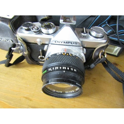 622 - PHOTOGRAPHY, an Olympus OM1 camera, together with a tripod, Canon binoculars, etc