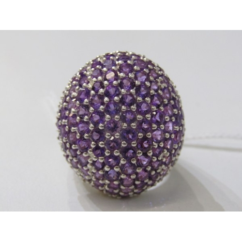 316 - STONE SET DRESS RING, large silver ring set with a cluster of purple stones, approximately 30mm spre... 