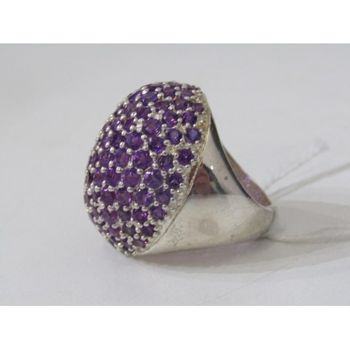 316 - STONE SET DRESS RING, large silver ring set with a cluster of purple stones, approximately 30mm spre... 