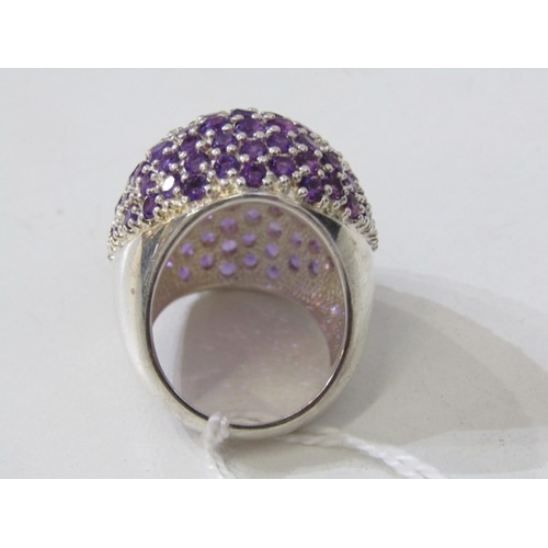 316 - STONE SET DRESS RING, large silver ring set with a cluster of purple stones, approximately 30mm spre... 