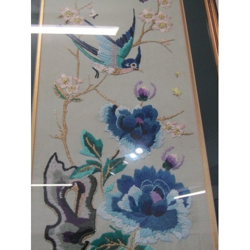 691 - ORIENTAL TAPESTRY, a pair of floral and bird decorated oriental influenced tapestry pictures