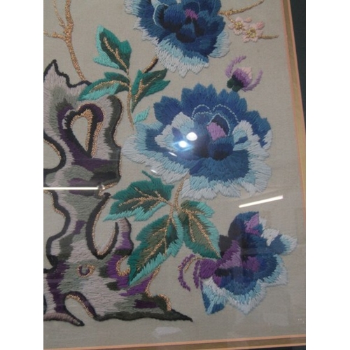 691 - ORIENTAL TAPESTRY, a pair of floral and bird decorated oriental influenced tapestry pictures