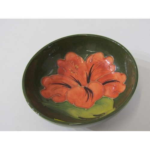 718 - MOORCROFT POTTERY, a Moorcroft trial piece pot and cover, florally decorated together with a green f... 