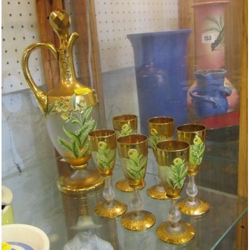 745 - GLASSWARE, a gilt and floral decorated glass wine ewer, together with 6 matching small wine glasses