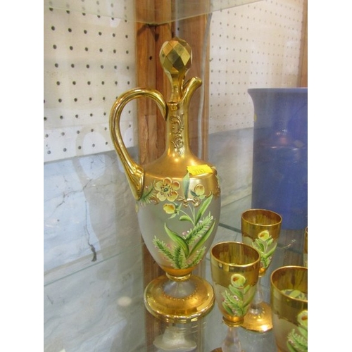 745 - GLASSWARE, a gilt and floral decorated glass wine ewer, together with 6 matching small wine glasses