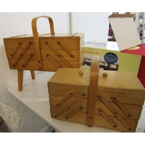 785 - MID CENTURY CANTILEVER SEWING BOXES, 2 wooden cantilever sewing boxes, one on 4 legs, with various c... 