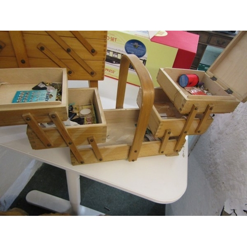 785 - MID CENTURY CANTILEVER SEWING BOXES, 2 wooden cantilever sewing boxes, one on 4 legs, with various c... 