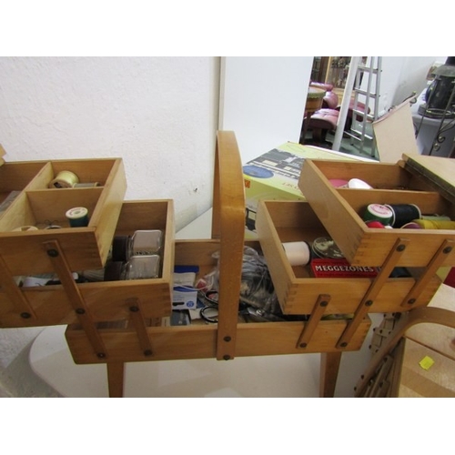 785 - MID CENTURY CANTILEVER SEWING BOXES, 2 wooden cantilever sewing boxes, one on 4 legs, with various c... 