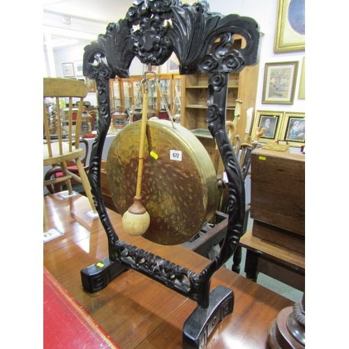 672 - DINNER GONG, a late 19th Century dinner gong, hammered brass gong on an ebonised oriental design fra... 