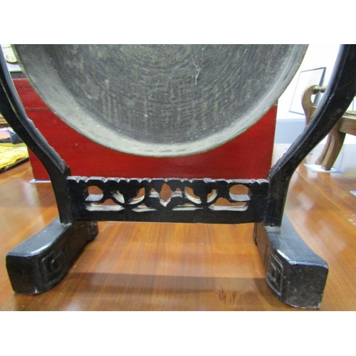 672 - DINNER GONG, a late 19th Century dinner gong, hammered brass gong on an ebonised oriental design fra... 