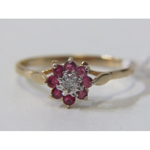 108 - RUBY & DIAMOND CLUSTER RING, 9ct yellow gold ring, set a central diamond surrounded by a cluster of ... 