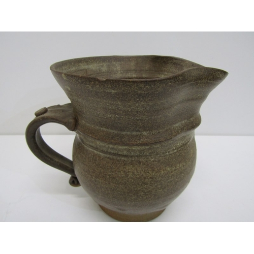 91 - STUDIO POTTERY, a studio pottery jug with light and medium brown glaze, twist handle (chip), 15cm he... 
