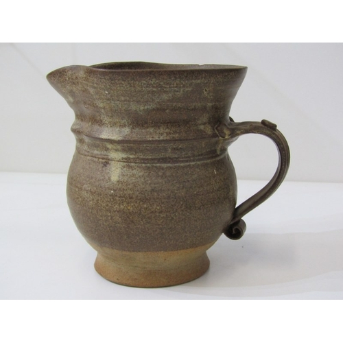 91 - STUDIO POTTERY, a studio pottery jug with light and medium brown glaze, twist handle (chip), 15cm he... 