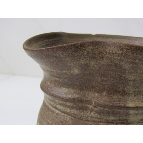 91 - STUDIO POTTERY, a studio pottery jug with light and medium brown glaze, twist handle (chip), 15cm he... 
