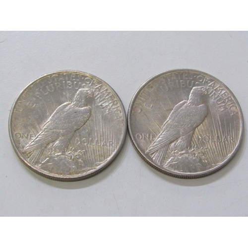 19 - 1922/1934 USA Silver ‘Peace Dollars both good examples in higher grade. 26.2 grams each