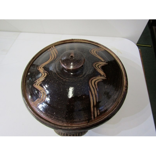 25 - WENFORD POTTERY CASSEROLE DISH, a lidded casserole dish with a dark brown glaze, incised with wavy l... 