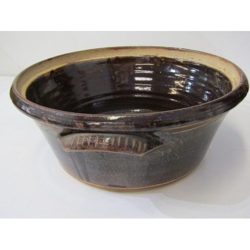 25 - WENFORD POTTERY CASSEROLE DISH, a lidded casserole dish with a dark brown glaze, incised with wavy l... 
