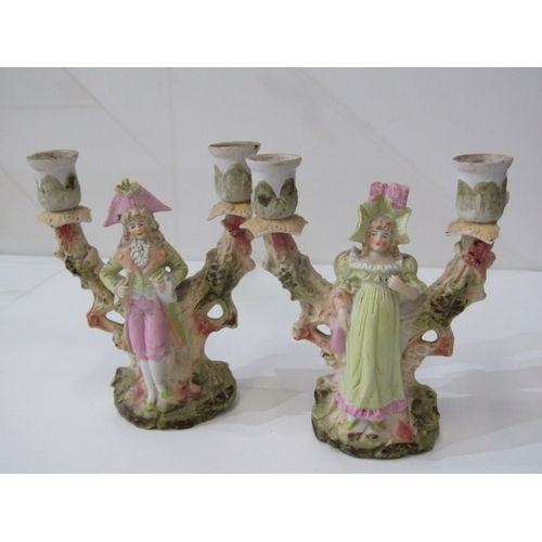 14 - PORCELAIN FIGURINES, a pair of 19th century continental candle holders with boy and girl to each. 18... 