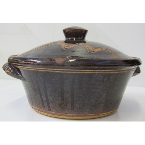 25 - WENFORD POTTERY CASSEROLE DISH, a lidded casserole dish with a dark brown glaze, incised with wavy l... 