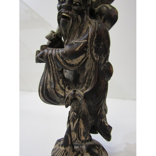 42 - ORIENTAL CARVINGS, a vintage Chinese carved wooden statue depicting a sage, such as Shou Xing, in th... 