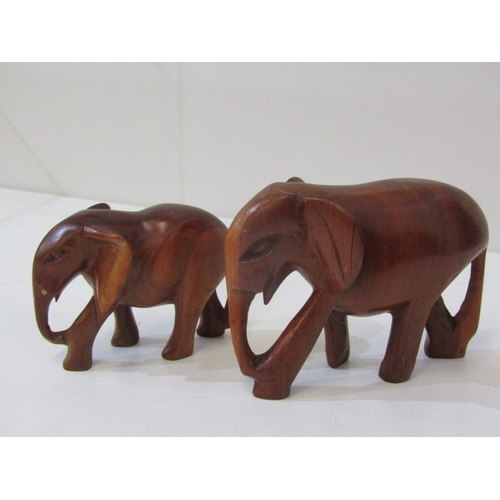 53 - ETHNIC CARVINGS, collection of carved wood animals including rhinos and elephants, ethnic masks and ... 