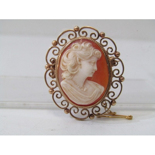 33 - CAMEO BROOCH IN ORNATE FRAME, classical oval cameo brooch in the form of a maiden in an ornate 9ct y... 