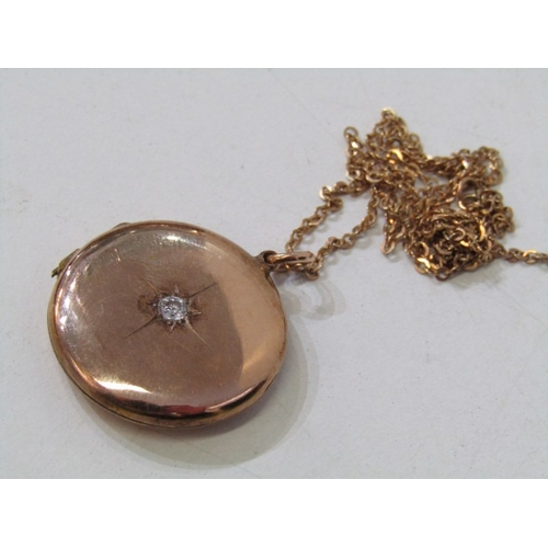 35 - GOLD LOCKET ON CHAIN, circular gold locket (tests as 18ct) set a round brilliant cut diamond, 2.5cm ... 