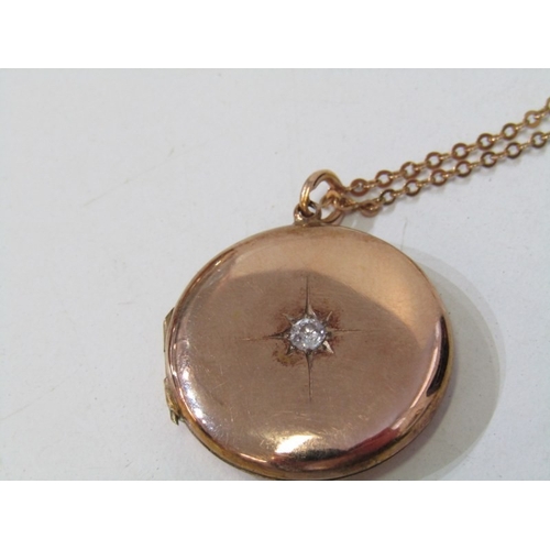 35 - GOLD LOCKET ON CHAIN, circular gold locket (tests as 18ct) set a round brilliant cut diamond, 2.5cm ... 