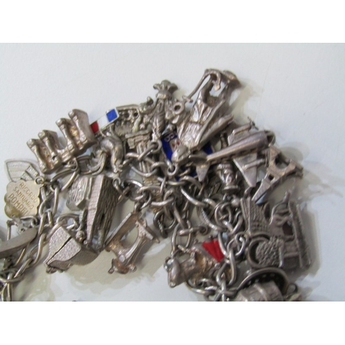 41 - EXTENSIVE SILVER CHARM BRACELET, charm bracelet with approx. 36 assorted charms of various forms, in... 
