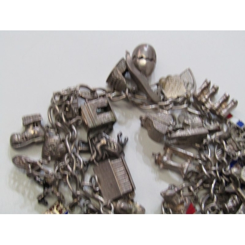41 - EXTENSIVE SILVER CHARM BRACELET, charm bracelet with approx. 36 assorted charms of various forms, in... 