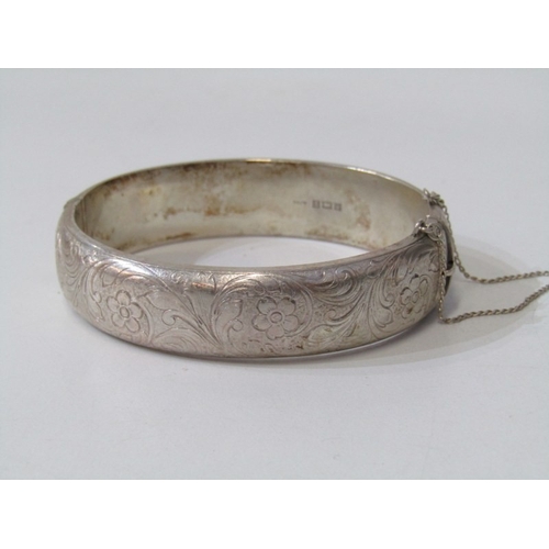 46 - SILVER BANGLE, silver hinged bangle with foliate engraved decoration, 35.4 grams