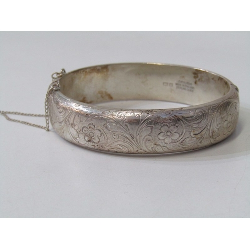 46 - SILVER BANGLE, silver hinged bangle with foliate engraved decoration, 35.4 grams