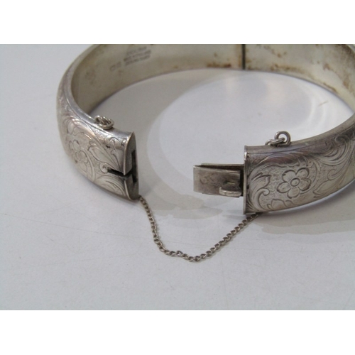 46 - SILVER BANGLE, silver hinged bangle with foliate engraved decoration, 35.4 grams