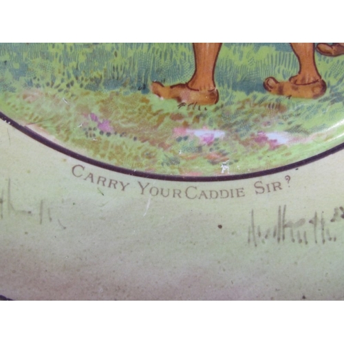 27 - GOLFING, a pottery plate c.1900 depicting a comical   golfing scene, titled 'Carry your Caddy, Sir?'... 