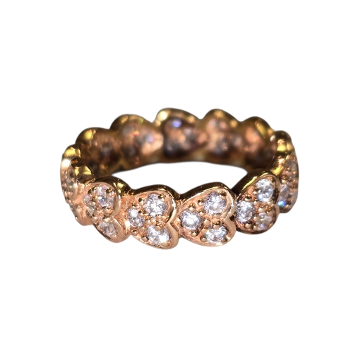 A 14ct gold diamond set eternity ring.
Of full eternity design, formed as a continuous band of heart-shaped settings, each collet set with small round brilliant-cut diamonds, the shoulders and interior plain polished. Stamped 14ct.
Ring size K.