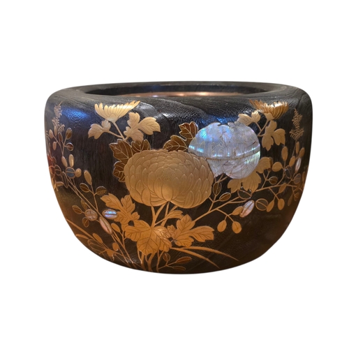 A Japanese Maki-e and Raden Lacquer Hibachi (Fire Bowl)
Meiji period (1868–1912), circa 1900–1910
Of rounded form with copper-lined interior, the exterior exquisitely decorated in gold maki-e lacquer with chrysanthemums, grasses, and trailing vine leaves, interspersed with raden (abalone shell) inlay creating iridescent highlights. The lacquer surface displays a fine tactile grain, typical of high-quality Meiji work. Retains a superb deep patina and comes with an original Lotus Arts de Vivre certificate of authenticity, confirming collection by the von Buren family in Japan.

Dimensions: 31 cm diameter × 20.5 cm high
Weight: approx. 3 kg