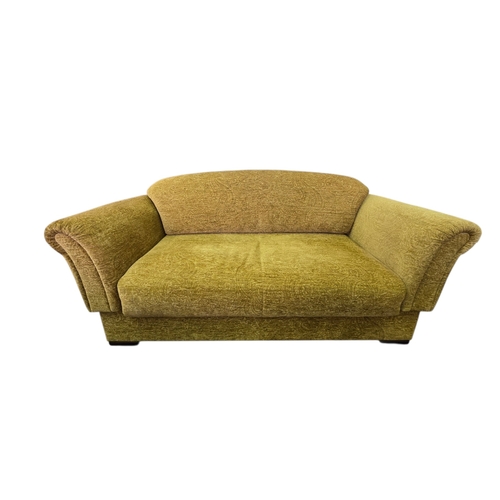 Parker Knoll Paisley Upholstered Two-Seater Sofa Bed / Day Bed, the shaped back and scrolling arms upholstered in Gold/Honey paisley-pattern fabric, the backrest and arms folding down to create a generous sleeping platform, raised on dark stained timber feet.
The companion lot also offered in this sale.