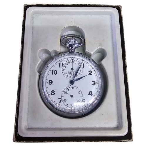 9 - A Vintage Heuer Mechanical Stopwatch, Boxed Circa 1960s–70s.
The chromed case with white signed dial... 