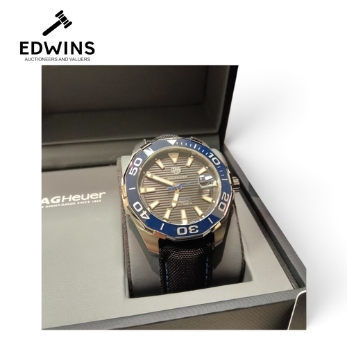 11 - A Gents Tag Heuer AQUARACER Automatic Wristwatch, 1000ft, with warranty card, tags, manual and inner... 