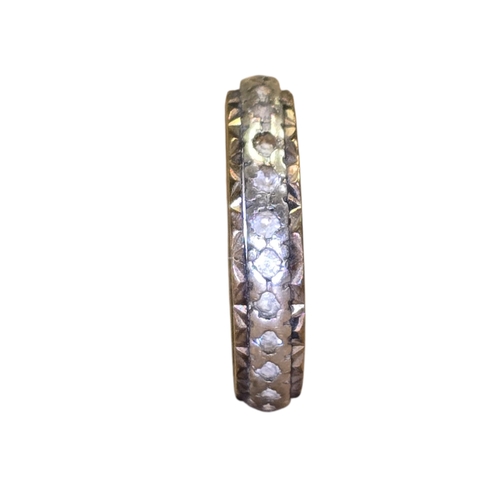 15 - A 9ct yellow and white gold eternity ring, set throughout with small white stones,
Marked 375, appro... 