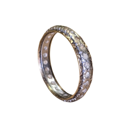 15 - A 9ct yellow and white gold eternity ring, set throughout with small white stones,
Marked 375, appro... 