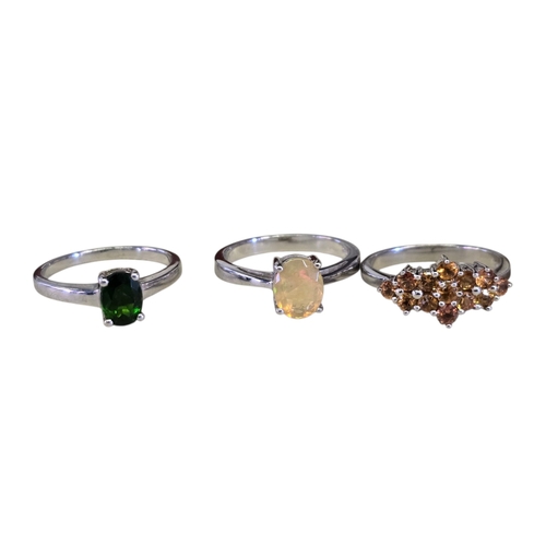 16 - A collection of 925 silver gem-set rings,
comprising a chrome diopside solitaire ring, size R½; an E... 