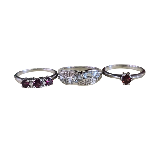 22 - A collection of 925 silver gem-set rings,
comprising a three-stone trilogy rhodonite garnet ring, si... 
