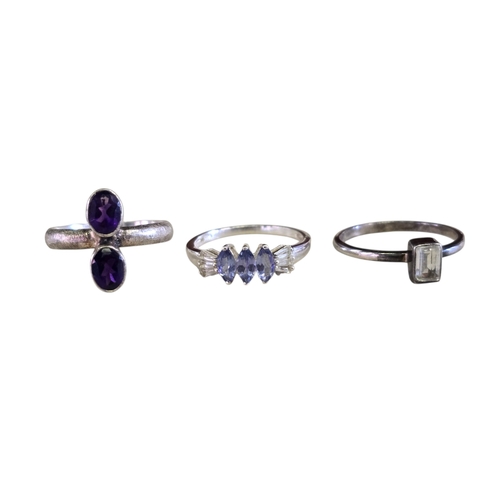 22 - A collection of 925 silver gem-set rings,
comprising a three-stone trilogy rhodonite garnet ring, si... 