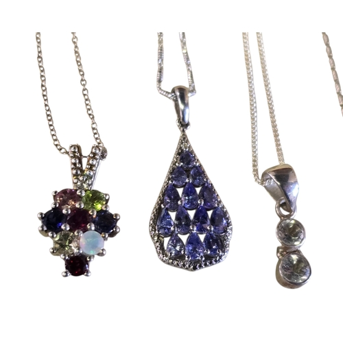 24 - A collection of six 925 silver gem-set pendant necklaces comprising a multi-gem cluster pendant set ... 