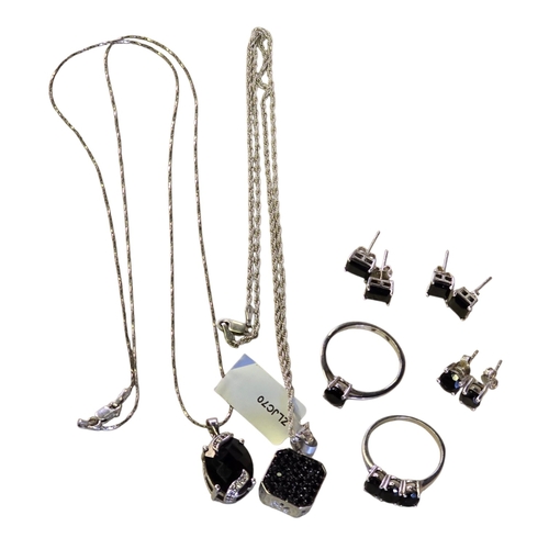 25 - A collection of 925 silver and black spinel jewellery, comprising two black spinel rings, sizes T½ a... 