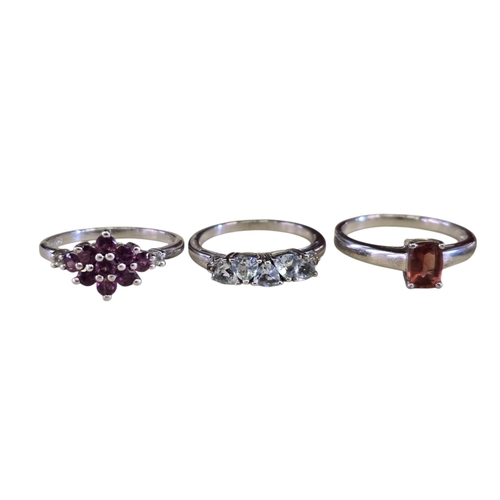 26 - A collection of 925 silver gem-set rings, comprising a floral rhodonite garnet ring, size T½; a Mong... 