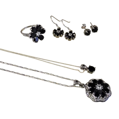 27 - A collection of black spinel and white topaz jewellery, comprising a floral cluster ring, size R.5, ... 