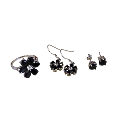 27 - A collection of black spinel and white topaz jewellery, comprising a floral cluster ring, size R.5, ... 