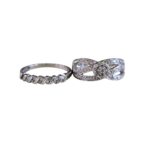 29 - A collection of 925 silver diamond-set ringscomprising four rings of various designs, including an i... 